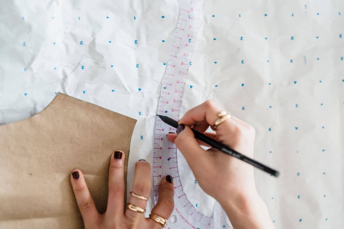 Tracing a neckline with a French curve on pattern paper