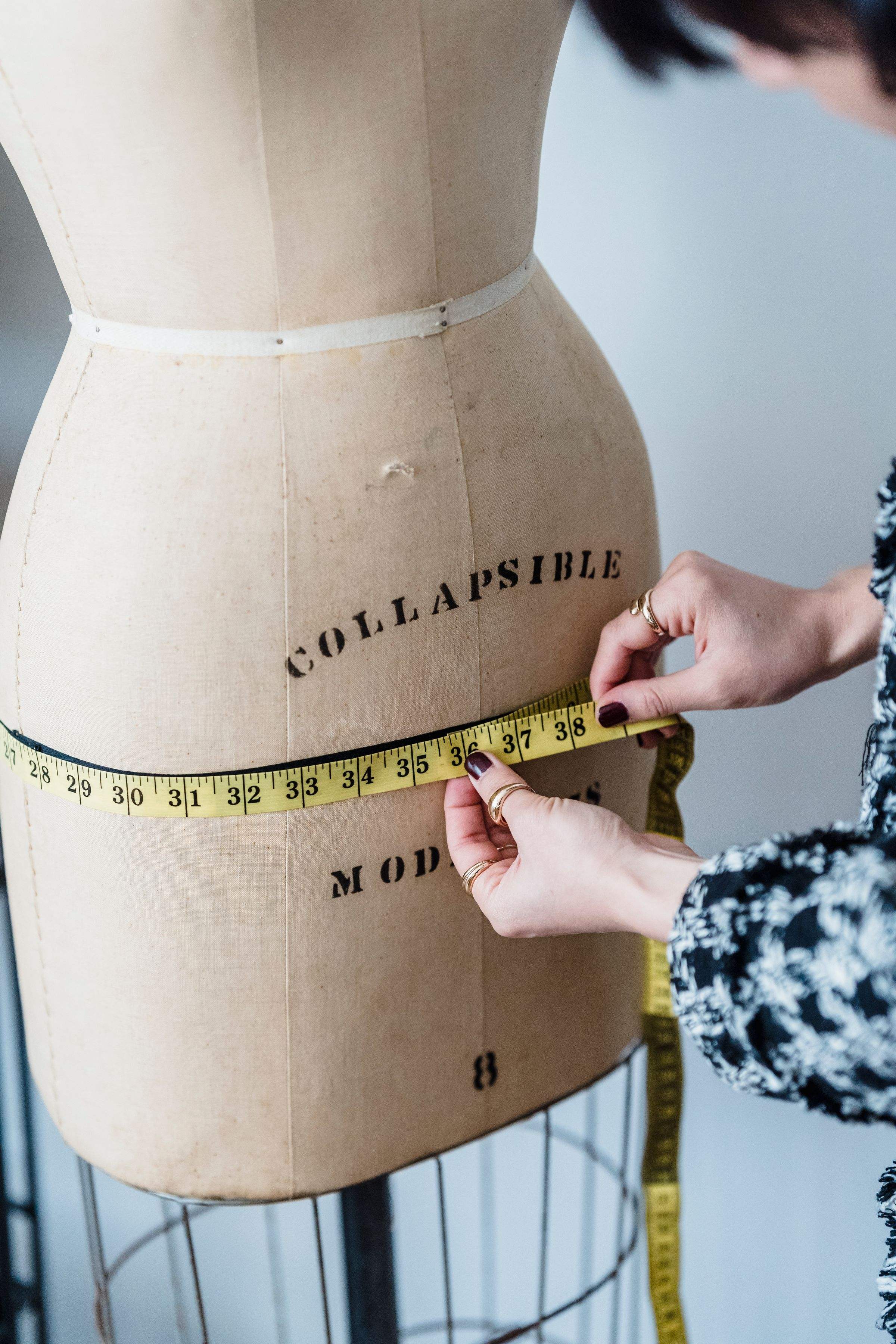 Measuring the waist of a dress form with a tape measure