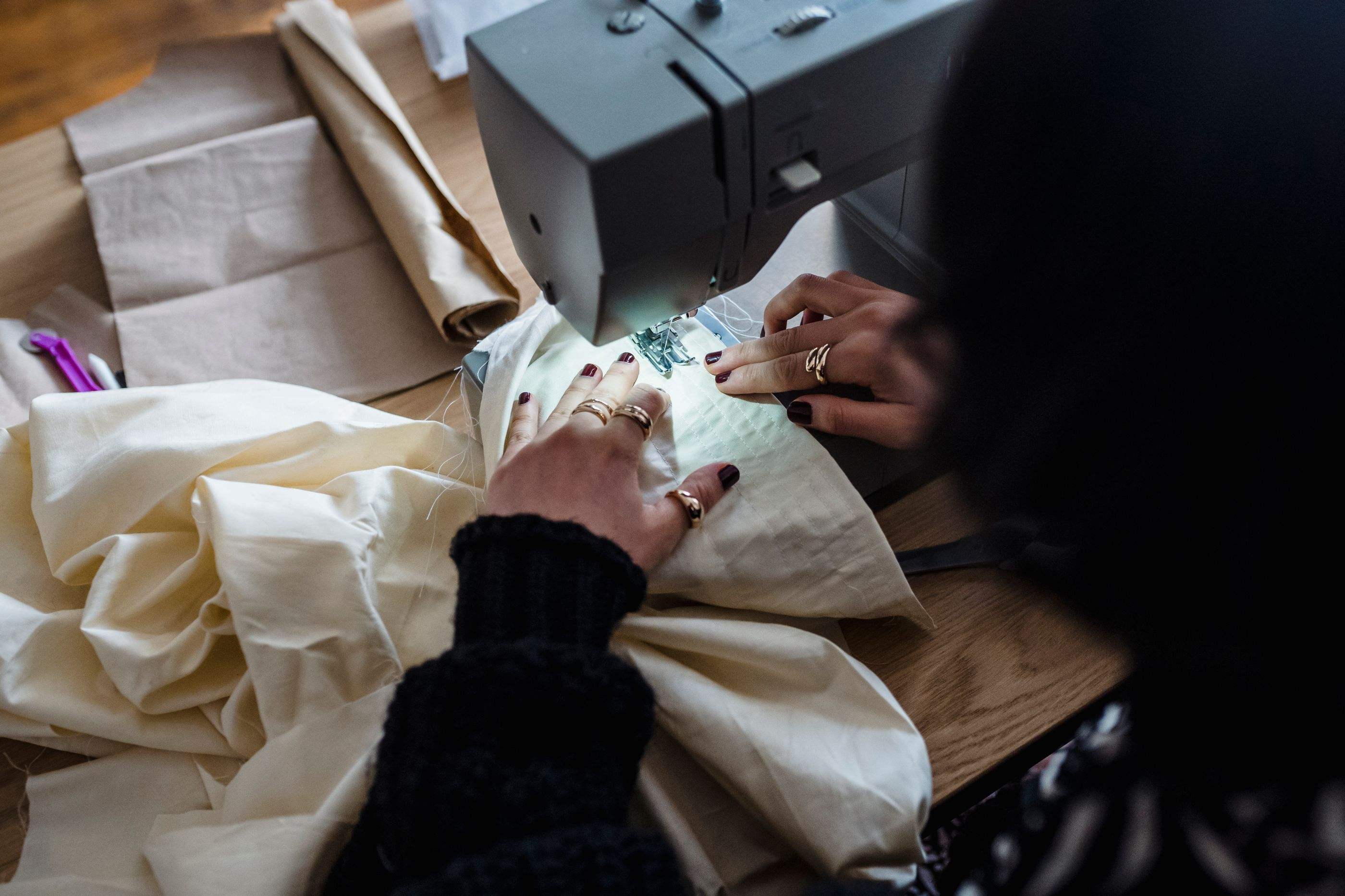 Guiding cream fabric through a sewing machine