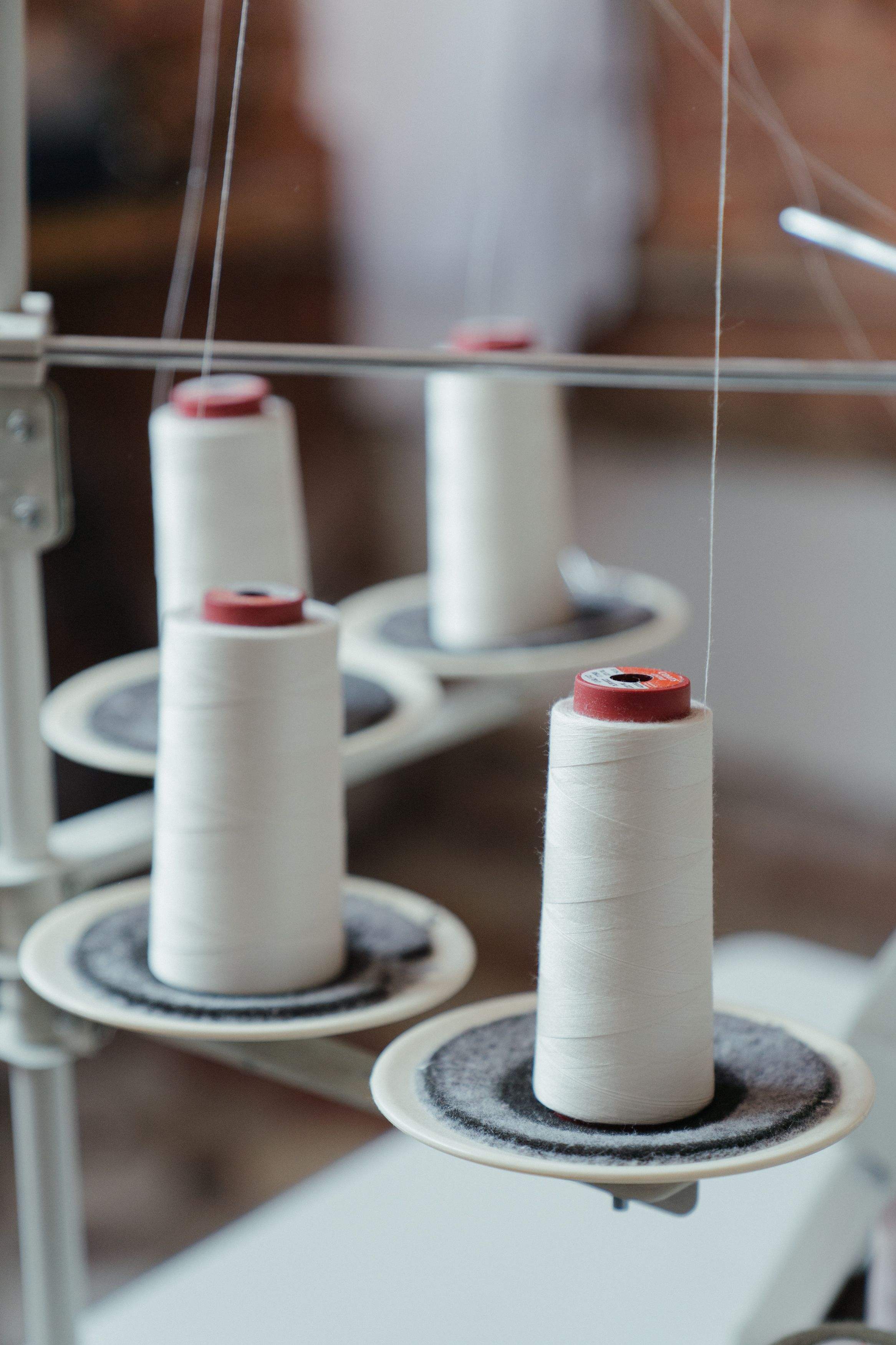 Cones of white thread feeding a machine